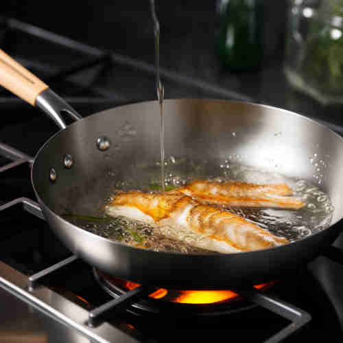 frying_fish_slice_in_stainless_steel_pan